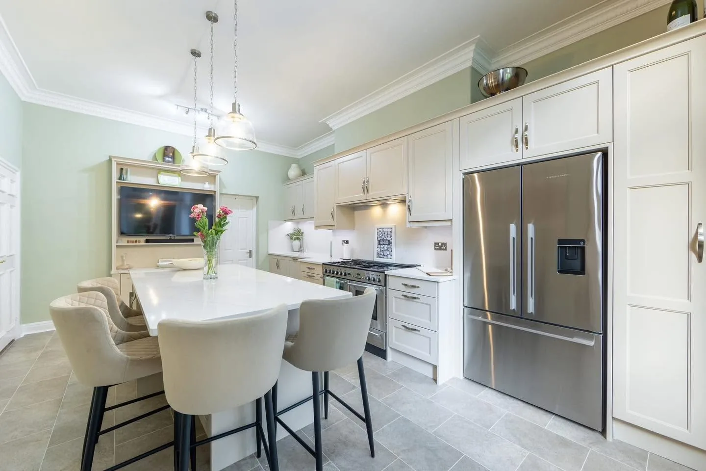 Light shaker kitchen with an island and American-style fridge
