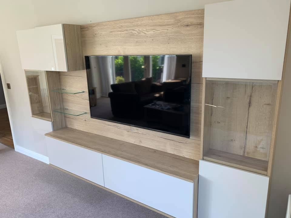 White and wood-effect fitted TV wall with display cabinets